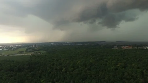 Powerful lightning strikes viewed by elevated drone in flight over forest - Stock Footage 104100513