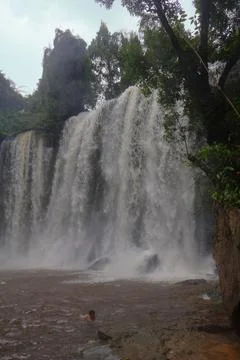 Powerful Main Waterfall Cascading into Misty Pool at Phnom Kulen, Cambodia Stock Photos