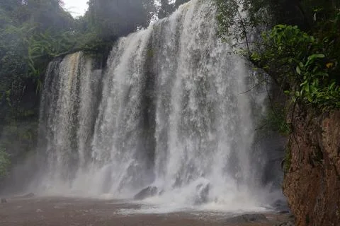 Powerful Main Waterfall Cascading into Misty Pool at Phnom Kulen, Cambodia Stock Photos