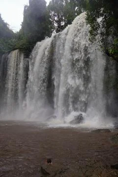 Powerful Main Waterfall Cascading into Misty Pool at Phnom Kulen, Cambodia Stock Photos