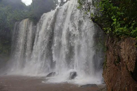 Powerful Main Waterfall Cascading into Misty Pool at Phnom Kulen, Cambodia Stock Photos