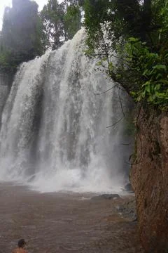 Powerful Main Waterfall Cascading into Misty Pool at Phnom Kulen, Cambodia Stock Photos