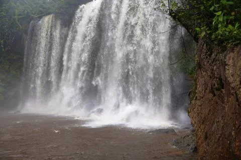 Powerful Main Waterfall Cascading into Misty Pool at Phnom Kulen, Cambodia Stock Photos