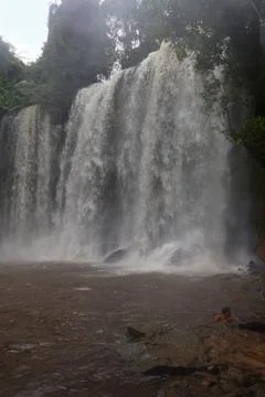 Powerful Main Waterfall Cascading into Misty Pool at Phnom Kulen, Cambodia Stock Photos