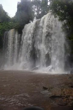 Powerful Main Waterfall Cascading into Misty Pool at Phnom Kulen, Cambodia Stock Photos