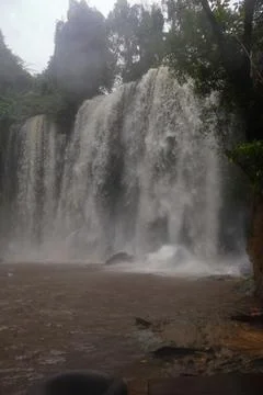 Powerful Main Waterfall Cascading into Misty Pool at Phnom Kulen, Cambodia Stock Photos