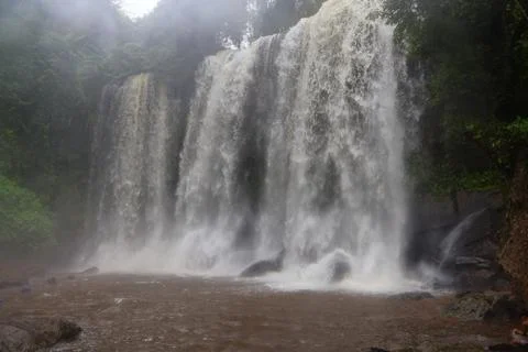 Powerful Main Waterfall Cascading into Misty Pool at Phnom Kulen, Cambodia Stock Photos