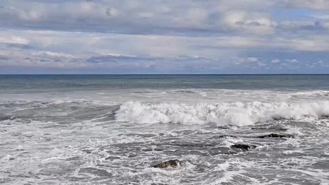 Powerful Maritime Currents Batter Jagged Rocks As Gloomy Clouds Gather Overhead Stock Photos