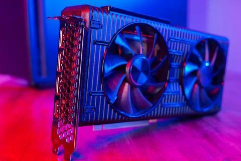 Powerful modern GPU Video Card with two fans with PC case on background in neon Stock Photos