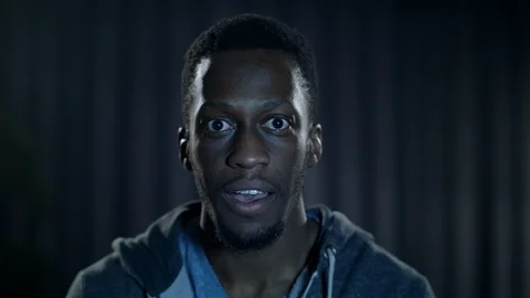 A powerful moment on tv causes a young man to react with shock and surprise Stock Footage 100168213
