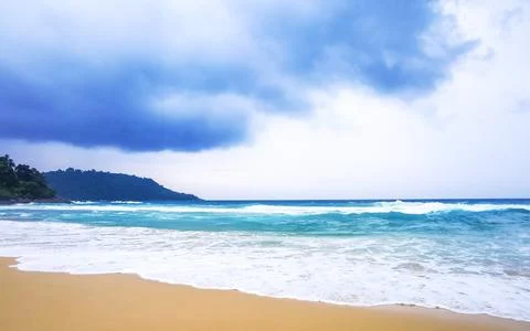 Powerful monsoon rain clouds above tropical beach with turquoise waves Kata.. Stock Photos