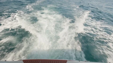 Powerful motorboat moving at high speed across the ocean, leaving a turbulent 스톡 동영상 337409848