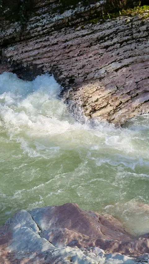 Powerful mountain river flowing through a rocky gorge creating white water Stock Footage 327727661