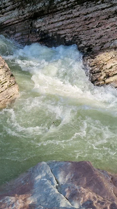 Powerful mountain river flowing through a rocky gorge creating white water Stock Footage 327727892