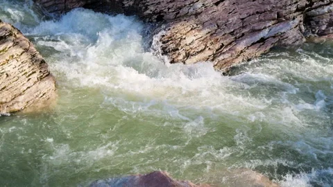 Powerful mountain river flowing through a rocky gorge creating white water Stock Footage 327729166