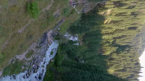 Powerful mountain river stream cascades over the rounded stones, Vertical video Stock Footage 318742420
