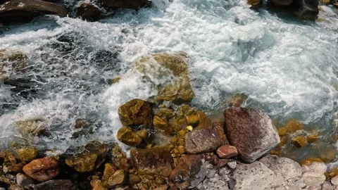Powerful mountain stream among rocks and boulders 動画素材 317706149