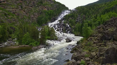 A powerful mountain waterfall in the forest Stock Footage 244651905