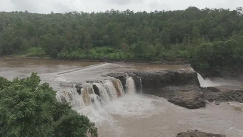 Powerful muddy-water waterfall Stockbeeldmateriaal 341945015