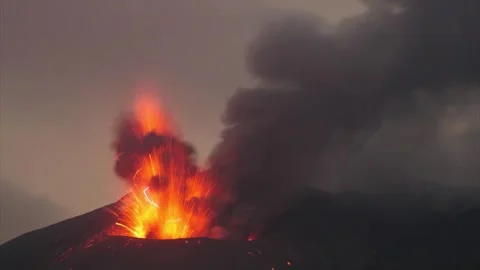 Powerful Night Volcanic Eruption with Red Lava Glow and Ash Cloud 4K Stock Footage 332158052