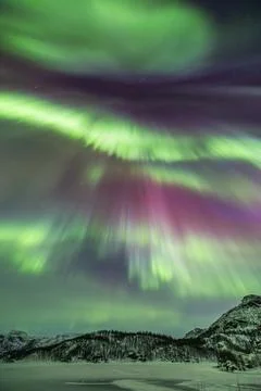 Powerful northern lights explode across the sky during an auroral substorm .. Stock Photos
