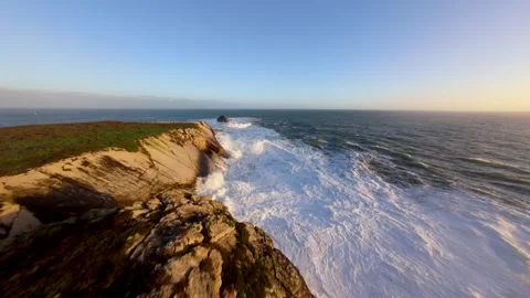 Powerful ocean meets jagged rocks Video stock 346075059