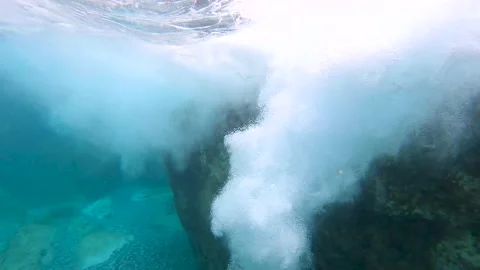 Powerful ocean wave breaking with underwater turbulence. Big waves break over co Stock Footage 169908208