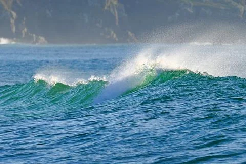 A powerful ocean wave with crystal-clear spray, ready for water sports Fotos Stock
