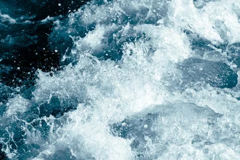 Powerful ocean wave splash with white foam and dark blue water Stock Photos