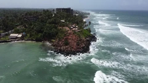 Powerful ocean waves breaking against rocky Coconut Hill in Mirissa Stock Footage 346569872