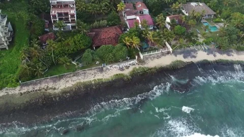 Powerful ocean waves breaking against tropical shoreline Stock Footage 346569931