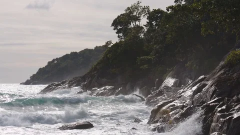 Powerful ocean waves breaking on a rocky shore during a storm Stock Footage 80014787