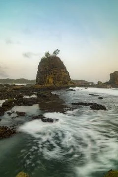 Powerful ocean waves captured with long exposure at Watu Lumbung Beach. Stock Photos