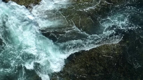 Powerful ocean waves clash against the rocky shore. Video stock 308608892