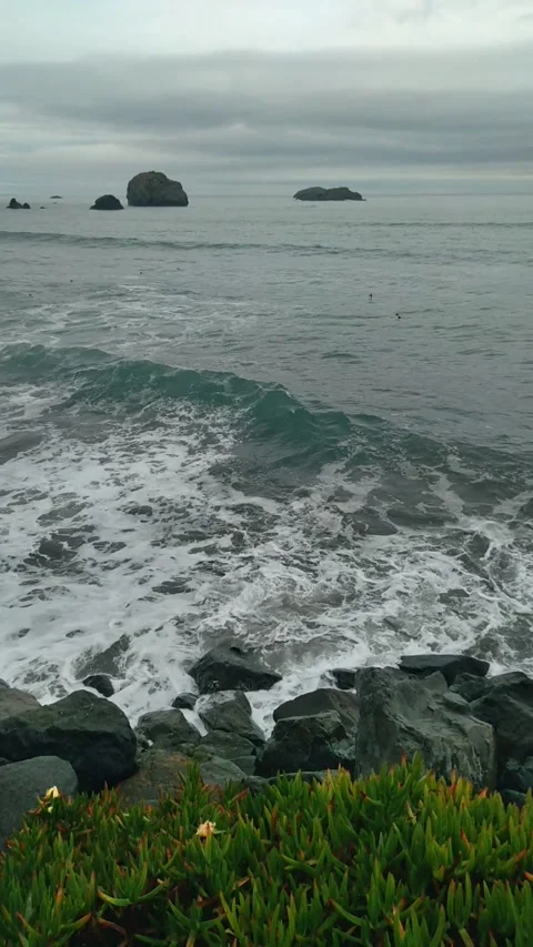 Powerful ocean waves crash against a stone walkway Stock Footage 316108259