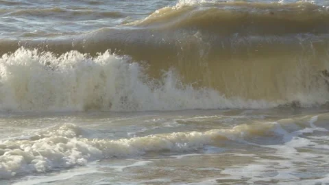 Powerful ocean waves crashing against rocky coast, displaying raw marine energy Video stock 308706552