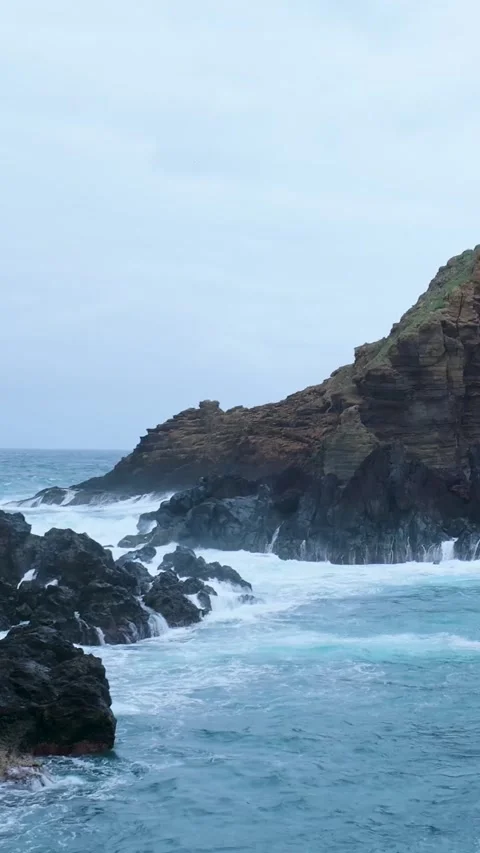 Powerful ocean waves crashing against rocky cliffs Stock Footage 334438939