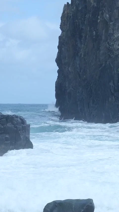 Powerful ocean waves crashing against rugged coastal cliffs Stock Footage 334440237
