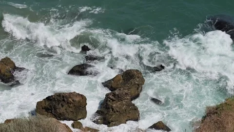 Powerful ocean waves crashing against rocky shore Video stock 342649779