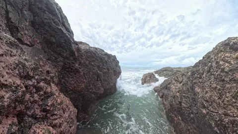 Powerful ocean waves crashing between dark rocky cliffs Stock Footage 344899485