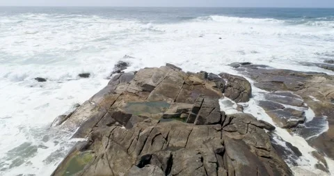 Powerful ocean waves crashing over large flat rocks The Concept of natural .. Stock Footage 336269569