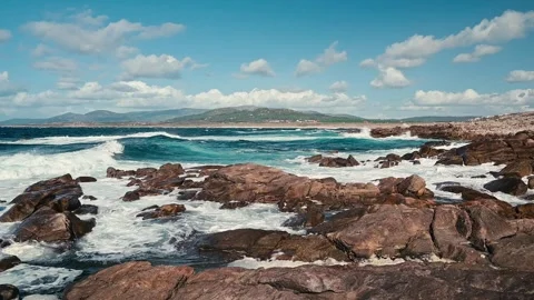 Powerful ocean waves crashing on a rugged coastline in Spain Video stock 320303568