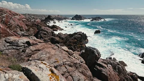 Powerful ocean waves crashing on a rugged rocky coast Video stock 320304427