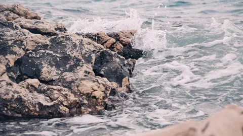 Powerful ocean waves crashing violently against dark coastal rocks coastline Stock Footage 337417759