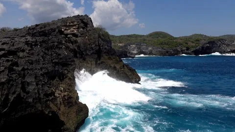 Powerful Ocean Waves Crashing on Volcanic Rocks at Angels Billabong Nusa Penida Stock Footage 332946764