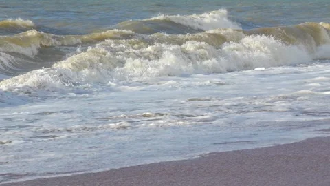 Powerful ocean waves generating white foam while crashing, slow motion sequence Video stock 308706703