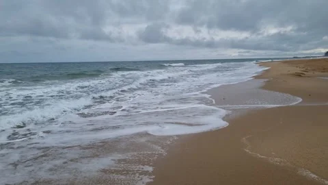 Powerful ocean waves rolling toward shore under dramatic cloudy sky Stock Footage 322040766