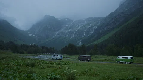 Powerful passable UAZ car rides on a bad road in a mountain valley. Slow motion Stock Footage 144030017