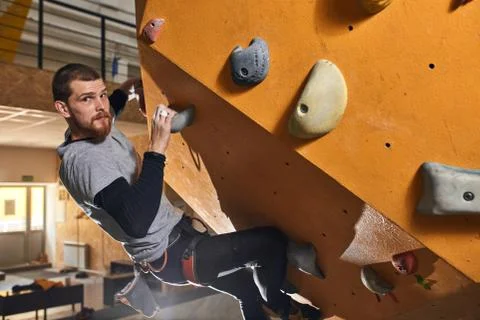Powerful physically challenged man training hard at climbing classes Stock Photos