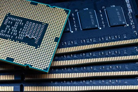 Powerful processor against the background of DDR DIMM RAM modules. Computer u Stock Photos
